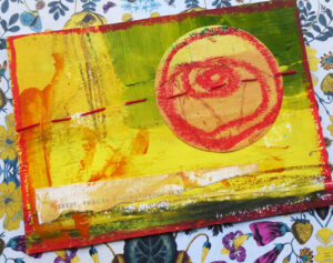 Handmade postcard decorated with paint, collage, crayon and stitch