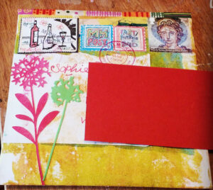 Upcycled envelope decorated with Gel plate print, die cuts and faux postage stamps -posted to France