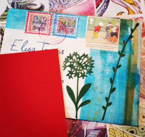 Handmade envelope decorated with Gel plate print, die cuts and faux postage stamps - posted to Italy