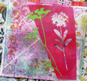Back of upcycled envelope decorated with Gel plate print and die cuts -  posted to Italy